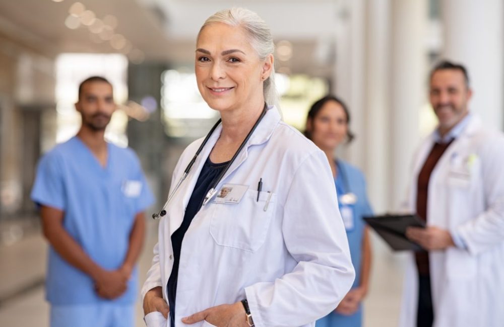 Portrait of mature female doctor on hospital corridor. Confident