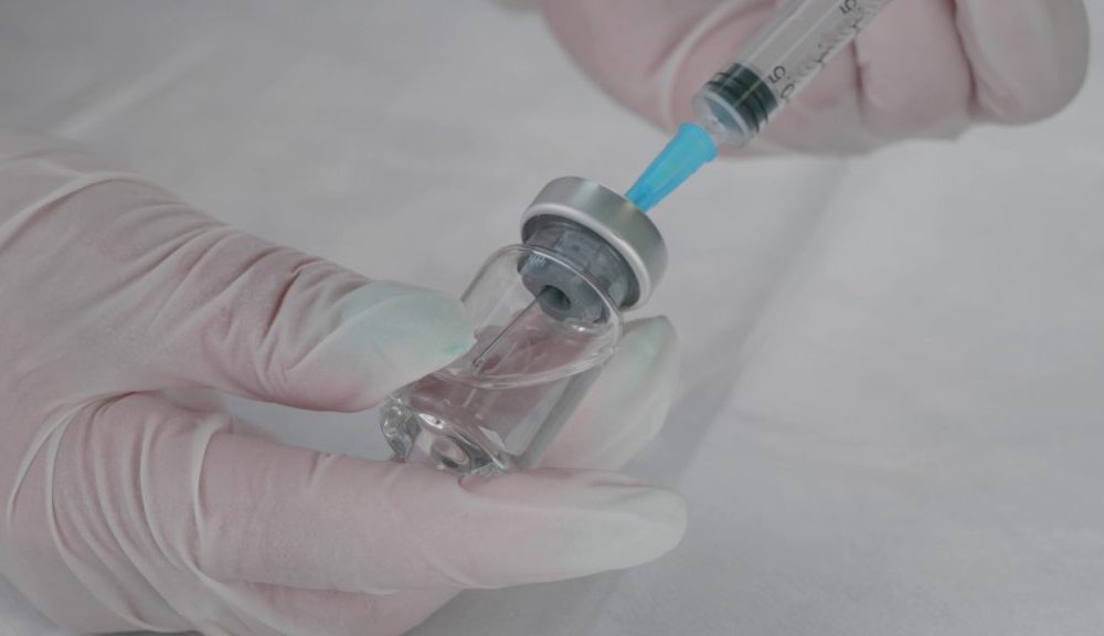 A Sterile Drug Is Taken In Gloves With A Syringe From A Glass Vi